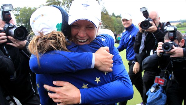 Suzann Pettersen hugs team-mate Azahara Munoz after winning the Solheim Cup for Europe.
