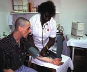 Salvation Army worker checking a man's blood pressure