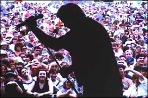 One of Twink's photos, showing the silhouette of a singer on stage in front of a concert crowd