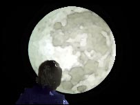 Boy silhouetted against the moon