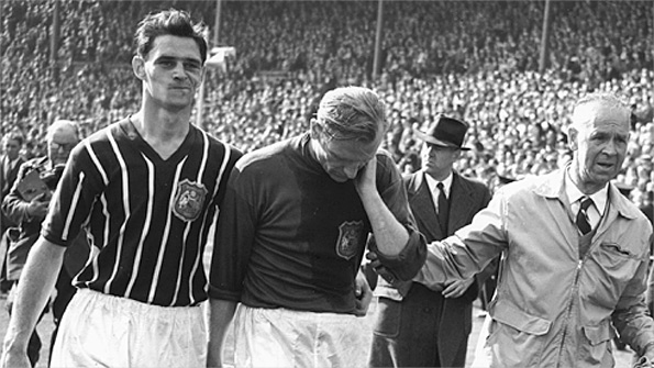Trautmann is helped off the field after his 1956 FA Cup final triumph