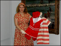 A lady holding old bathing costumes
