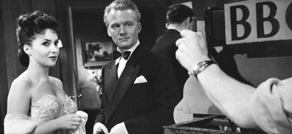 Picture shows Italian film stars and studio personalities in the studio during Italian Film Week, 1952. In this programme, which coincided with the opening of the festival week of Italian films in London, viewers saw extracts from four of the eight festival films. John Fitzgerald, who introduced the programme, with actress Gina Lollobrigida.