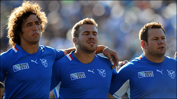 Burger (far left) lines up with his team before the game against Fiji