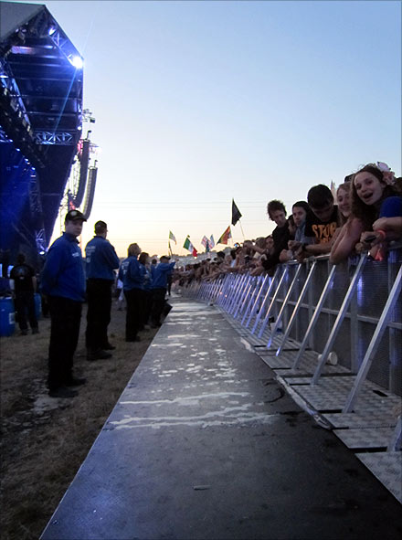 The security team constantly hands water to the crowd at the front of the mosh pit