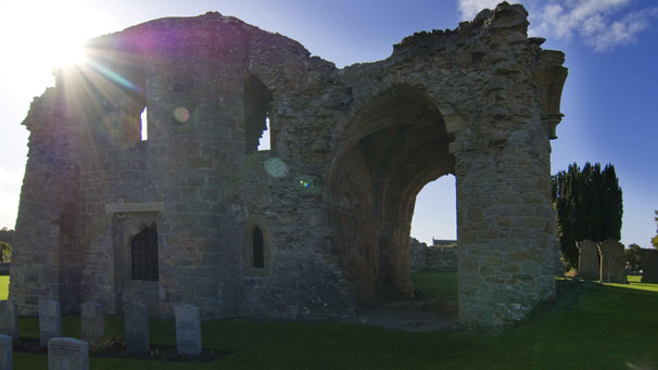Sun bursting through an ancient abbey