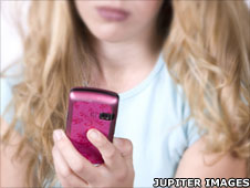 Teenager with mobile phone (posed by a model)