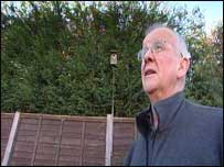 Man next to leylandii hedge