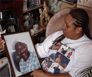 woman seated holding photo of black man