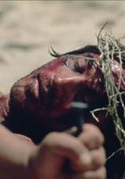 Somebody removing nails from the dead Jesus's hands