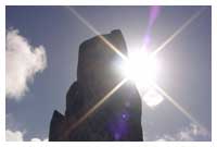 Sun behind Orkney standing stone - photo by Nick Dempsey