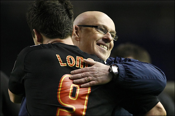 Shane Long (left) embraces his manager Brian McDermott.