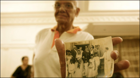 Joel Solomon holds up a picture of his wedding