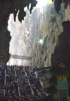 Dramatic stalactites frame the high-ceilinged interior of the cave