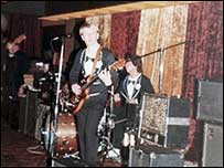 A band on stage from the 1980s.