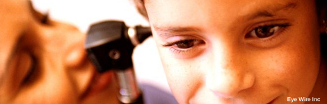 Doctor looking inside a child's ear