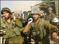 Yaralı arkadaşlarını taşıyan İsrail askerleri