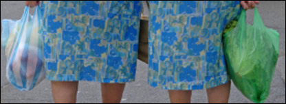 Two ladies carrying plastic shopping bags