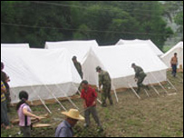 Soldiers busy erecting tents