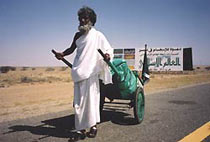 Pilgrim with a handcart to carry his belongings