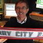A life long fan - John in the BBC Radio Ulster studios with his Derry City FC scarf