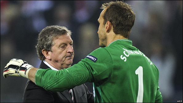 Hodgson embraces goalkeeper Mark Schwarzer after the game
