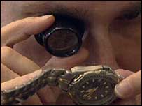 jeweller examining watch