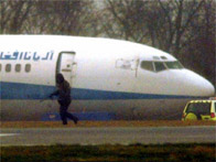 Special forces officer patrols by a hijacked passenger aircraft
