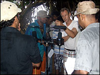 Director Willi Richards centre white T shirt directs cast on Mt. Lavinia beach in monsoon (photo: Roger Elsgood)