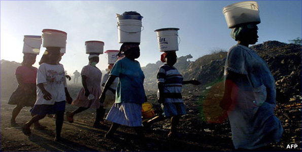 Women carrying buckets on their heads in Africa