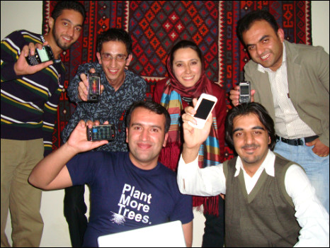 Afghan bloggers hold up their internet enabled mobiles.