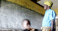 Old woman and child running at a school in Ghana
