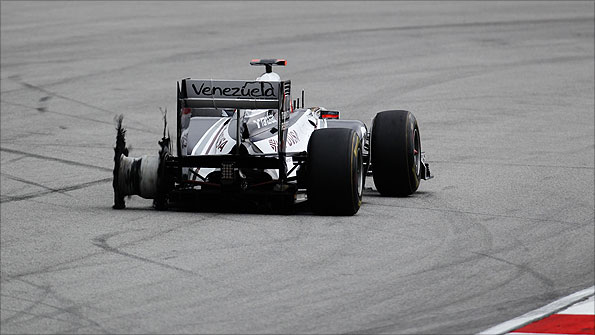 A Williams returns to the pits with a shredded tyre