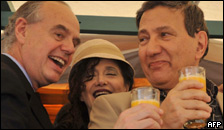 Three people drinking orange juice