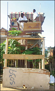 Two men enjoy the view from their double-storey shack in the Diepsloot squatter camp outside Johannesburg