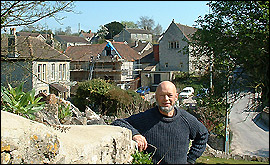 Michael Eavis in front of the working mens club and village hall