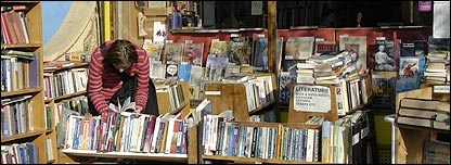 Someone looking for a book in a small bookshop