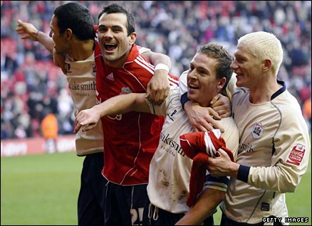 Barnsley's Brian Howard celebrates with Martin Devaney (c-l), Anderson De Silva (l) and Bobby Hassell (r) after their win over Liverpool in the FA Cup fifth round