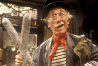 A sturdy french farmer waving sausages