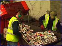 Image of two men sorting out cans for recycling