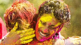 Young Indian people celebrate the Hindu festival of Holi by throwing coloured powder called Gulal at each other