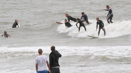 Surfers sharing a wave