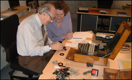 Bletchley Park expert Tony Sale, pictured with his wife Margaret, repairing Jersey's Enigma machine