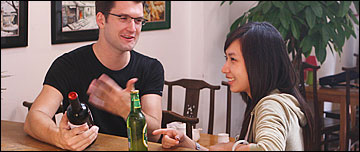A man and women chatting in a bar