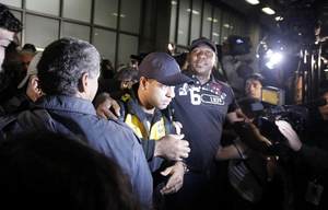 Brazil's Felipe Melo is escorted by police after arriving back in Rio de Janeiro - REUTERS/Bruno Domingos