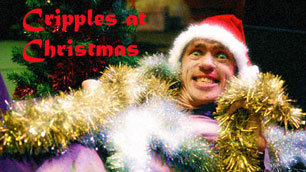 Mat Fraser, decked in tinsel, wearing a Santa hat, and smiling a huge grin