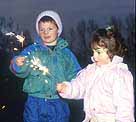 Photograph showing two kids holding sparklers