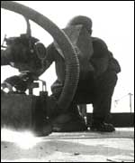 A welder working on a ship