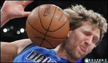 A ball bounces off a basketball player's head