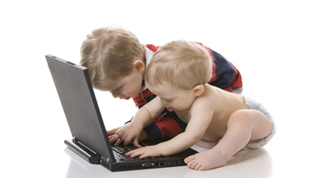 Two children playing with a laptop